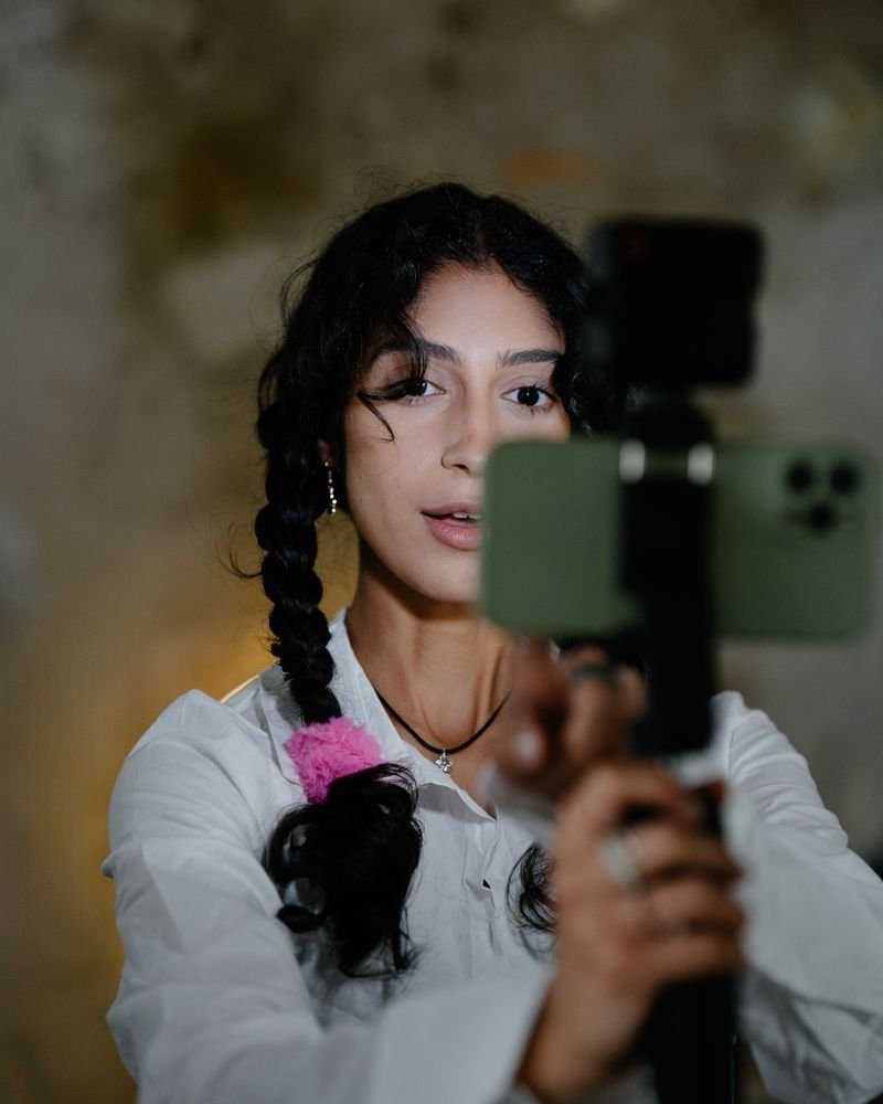 A creator recording vertical video on a smartphone gimbal