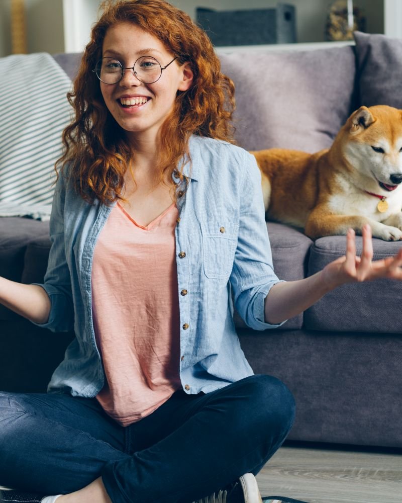 A creator recording a relaxed lifestyle video at home with a dog