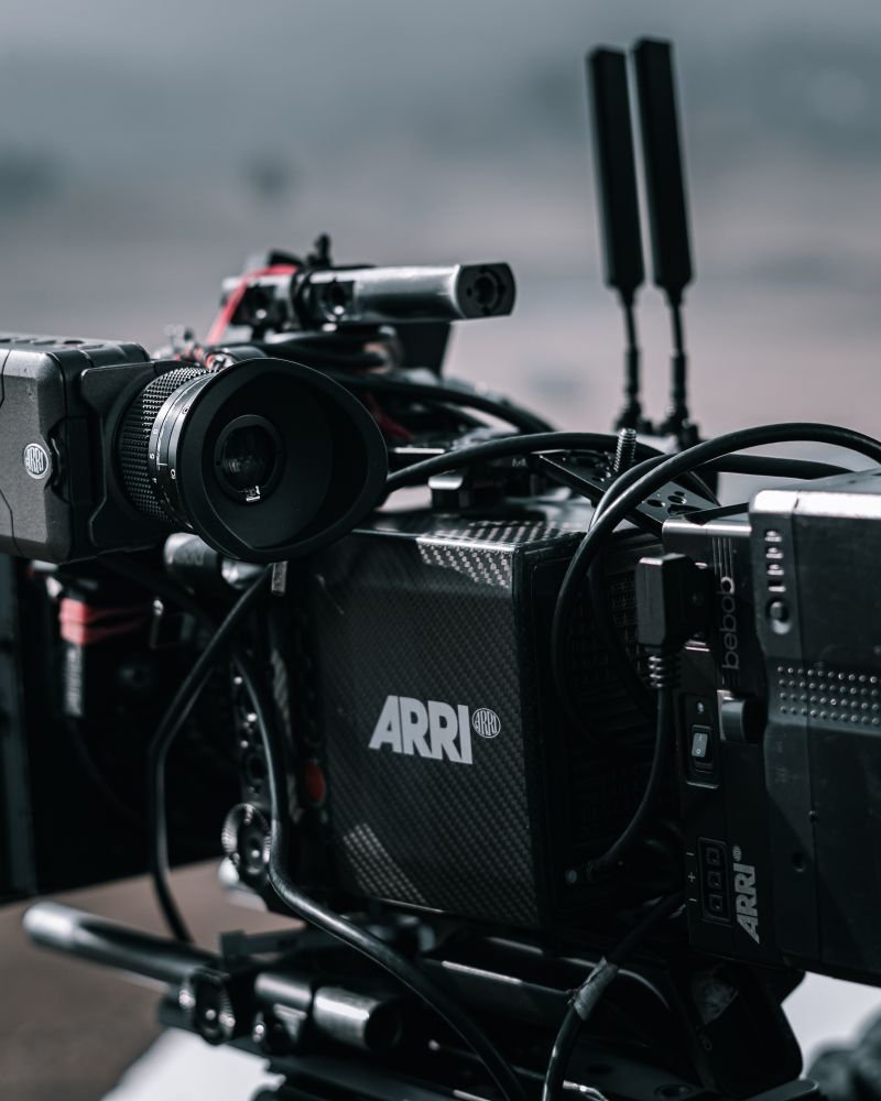 A professional cinema camera built out on a tripod for a shoot