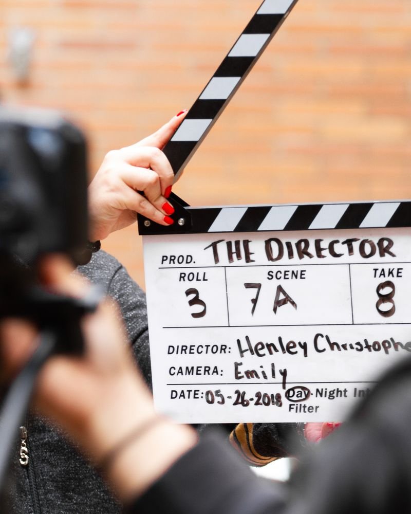 A film clapperboard held in front of a camera on set